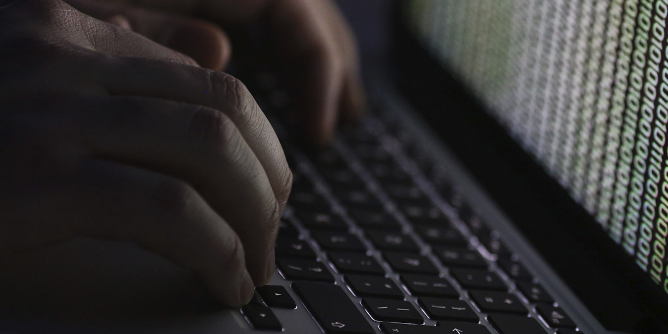 hands typing on a macbook